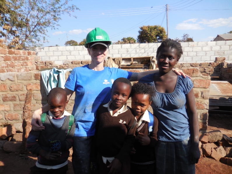 Me with Margaret after hauling concrete blocks... and three neighbourhood boys who bombed our photo!